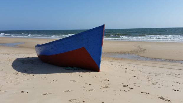 La patera encallada en la costa de Matalascañas este domingo